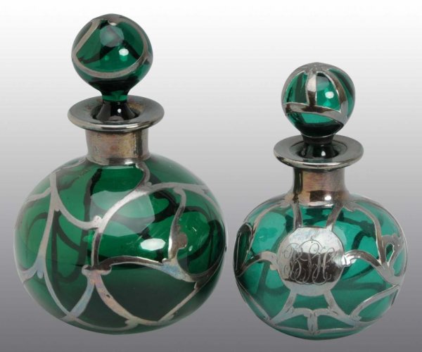 Lot of 2: Sterling Silver Overlay Bottles.: Description Both green glass and include original stoppers with no damage. Condition (Excellent). Size Largest: 3 - 3/4" T.