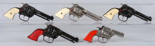 Lot of 5: Cast Iron Cap Guns.: Description Includes Hubley Cowboys. The one with the red grips is warped on both top and bottom. G-Boy gun has cracks in one grip. All working. Condition (Very Good). Size Largest: 8 - 1/4" L.