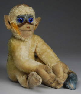 Large Steiff Mohair Monkey.: Description Germany, circa 1940s. Sitting monkey with long arms and tail and lovely coloration, green, gold, and blue. Jointed neck with large blue eyes. No tags or labels. Slight soiling and several