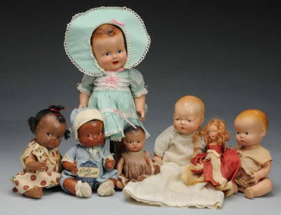 Lot of 7: Composition Dolls.: Description American, Ca. 1930s. Marked Baby Sandy of the Movies, all-composition with molded hair, painted eyes, (some crazing, repainted lips) nicely redressed with original Baby Sandy pin. Black