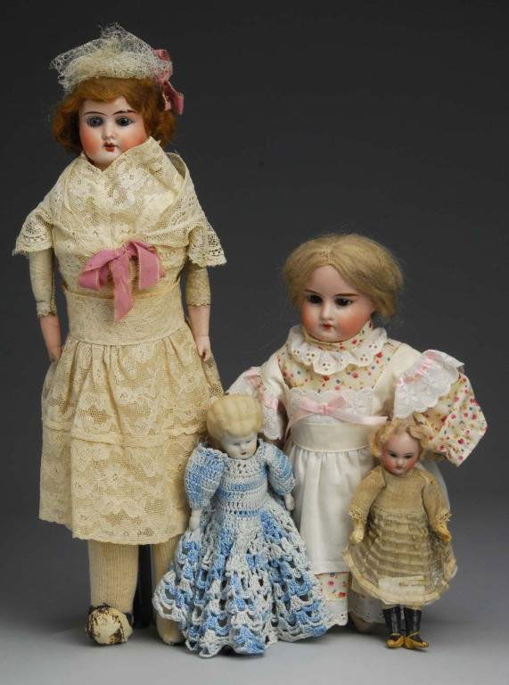 Lot of 4: Bisque Head Dolls.: Description Germany, Ca. 1890-1910. Bisque shoulderhead incised Lilly 8/0 Made in Germany set glass eyes, open mouth, original mohair wig, new cloth body and clothes. Bisque shoulderhead incised Mable