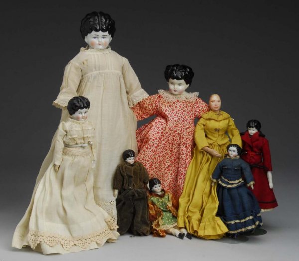 Lot of 8: China & Papier-Mache Dolls.: Description Germany, Ca. 1900, and later. Five antique china heads with 1890s hairdos, cloth bodies, bisque lower limbs, all dressed, some original. One 1860s china, cloth body, bisque limbs, original