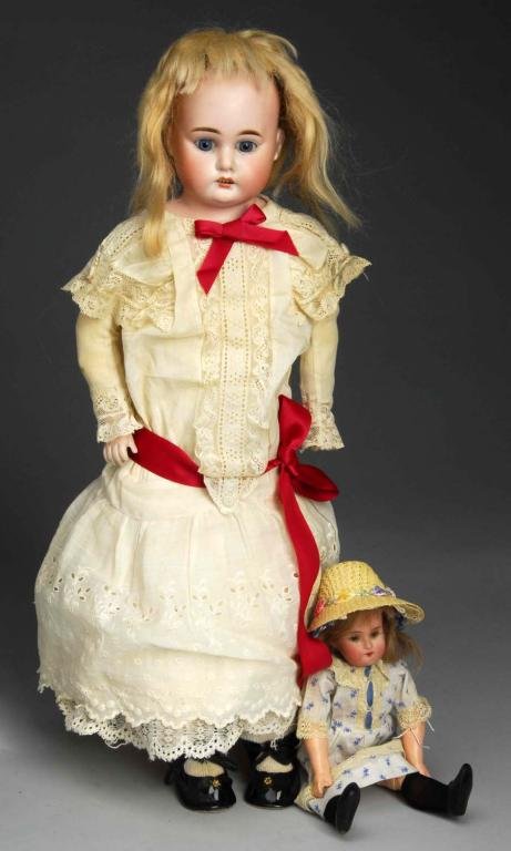 Lot of 2: Bisque Dolls.: Description Germany, Ca. 1895. Bisque shoulder head incised COD 93 9 DEP, made by Armand Marseille for Cuno & Otto Dressel, set eyes (never slept), original mohair wig, open mouth, multi-stroked eyebr