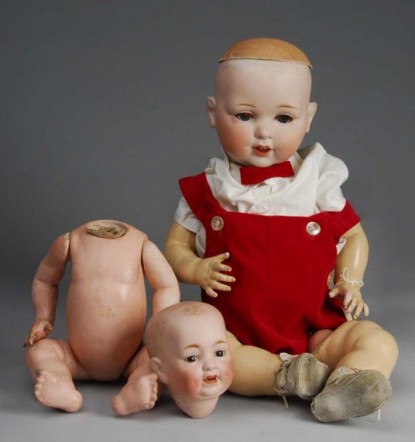 Lot of 2: Bisque Baby Dolls.: Description Germany, Ca. 1910. Bisque socket head incised A 980 M Germany 16 DRGM, blue sleeping eyes with replaced curly upper eyelashes, open mouth with two upper teeth and tongue, no wig, compositi