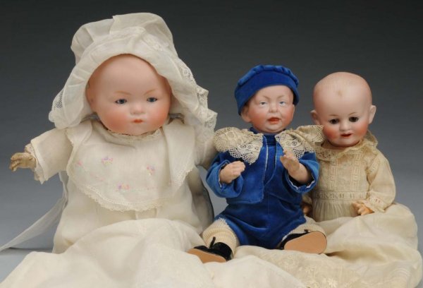 Lot of 3: Bisque Head Character Babies.: Description German, Ca. 1910-20s. A.M. 341 baby on cloth body with composition hands; Franz Schmidt & Co. 1272 baby with sleeping eyes, pierced nose on composition baby body; K & R 100 Baby on composi