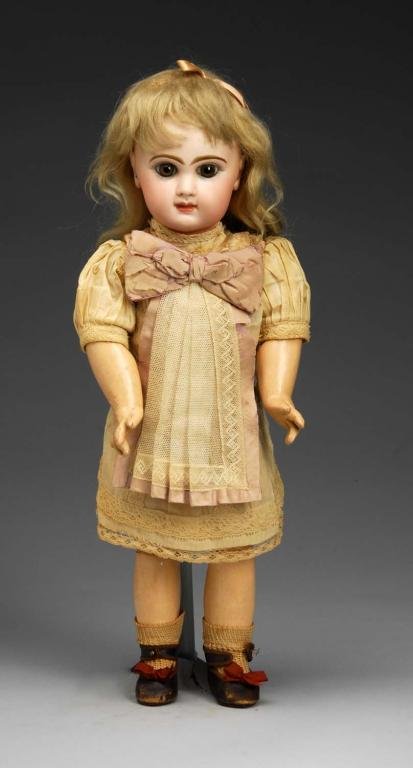 Tete Jumeau Bebe with Closed Mouth.: Description French, Ca. 1880. Bisque socket head stamped in red Depose Tete Jumeau Bte. SGDG 7. Dark eyebrows, brown paperweight eyes, painted upper and lower eyelashes, closed mouth, pierced ears, co