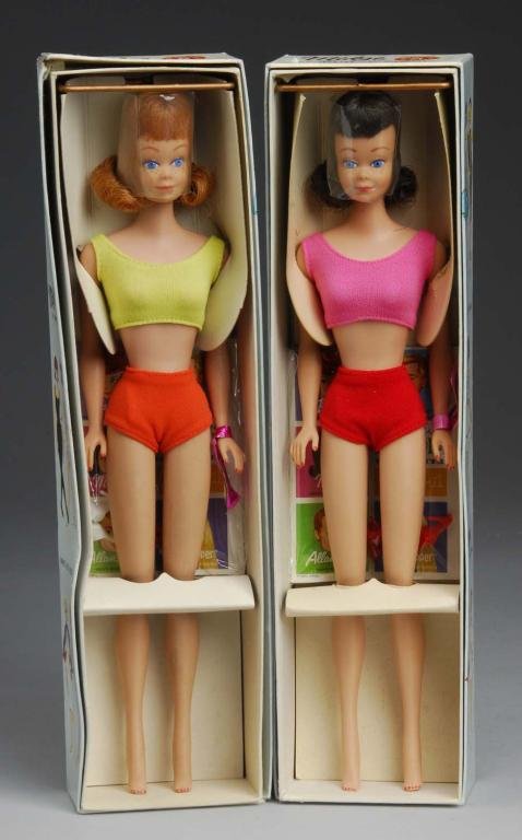 Pair of Midge Dolls.: Description One titian #860 boxed with wrist tag, stand, booklet and shoes, plastic wrap still on head. One brunette #860 boxed with wrist tag, stand, booklet and shoes, plastic wrap still on head. Co