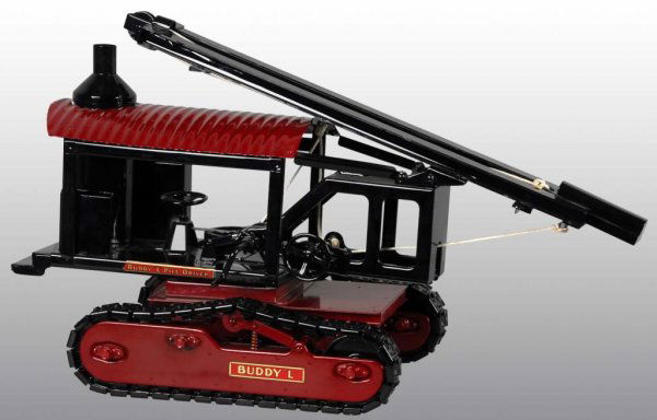 Pressed Steel Buddy L Pile Driver On Treads Toy.: Description American. T production. New old stock. Exact reproduction of the original Buddy L model toy. Limited model. One of four treaded railroad construction toys. Size 15" x 27".