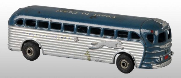 Cast Iron Arcade Coast to Coast GMC Bus Toy.: Description American. Marked "Coast to Coast GMC" on roof and "Greyhound Lines" with racing greyhound dog embossed on sides of bus. Arcade toy sticker on bottom and black rubber tires. Some chipping t