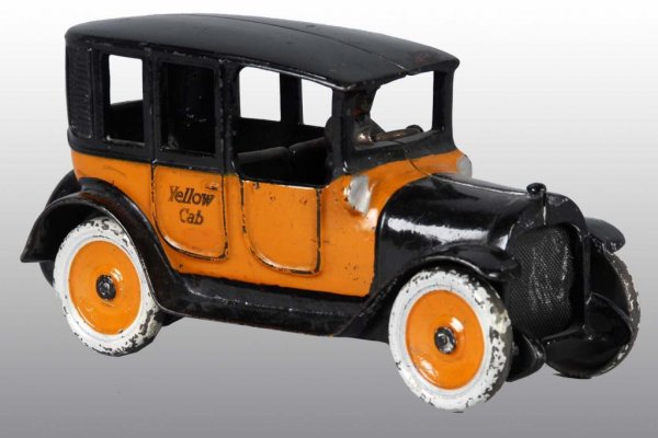 Cast Iron Arcade Yellow Cab Toy.: Description American. "Yellow Cab" stamped on outside of rear doors. Separate original driver and molded spare tire. Some paint loss on front of roof and chipping to white on wheels. Condition (Very G