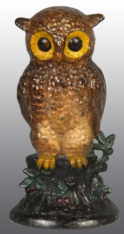 Cast Iron Owl on Stump Doorstop.: Description Attributed to Hubley, cat. #254. Realistic depiction of owl sitting on tree stump with leaves and red berries adorning the stump. Classic pose with vivid detail. Unusual paint variation. C