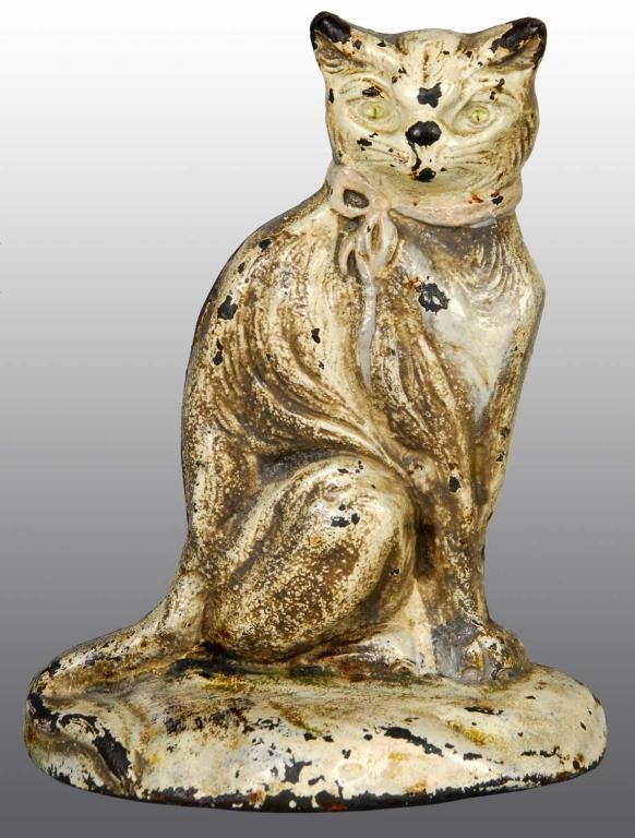 Cast Iron Sitting Cat Doorstop.: Description Made by "Johnson". Depicts sitting cat wearing pink bow. Detailed casting. Condition (Very Good). Size 6" x 4 - 3/4".