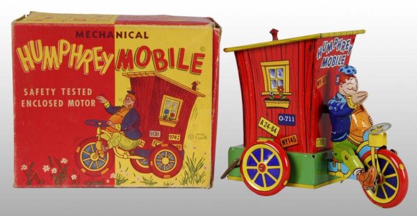 Wyandotte Humphrey Mobile Wind-Up Toy.: Description American. Working. Original hat, steering wheel, smoke stack and back door. Toy is bright and shiny with minor scratching and missing plastic stovepipe on top. Includes complete original b