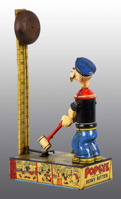 Tin Chein Popeye Heavy Hitter Wind-Up Toy.: Description American. Working. When wound, Popeye swings mallet down and rings bell. Nice graphics of Popeye characters around sides of base. Some rust to bell and both of Popeye's cheeks have litho l