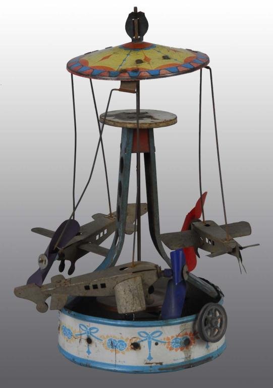 Wilhelm Krauss Flying Carousel Steam Toy.: Description German. Circa 1930. Marked "WK" on top. Three Folker airplanes fly around this steam toy accessory. One propeller is broken in half with moderate overall wear and some oxidation to cellulo