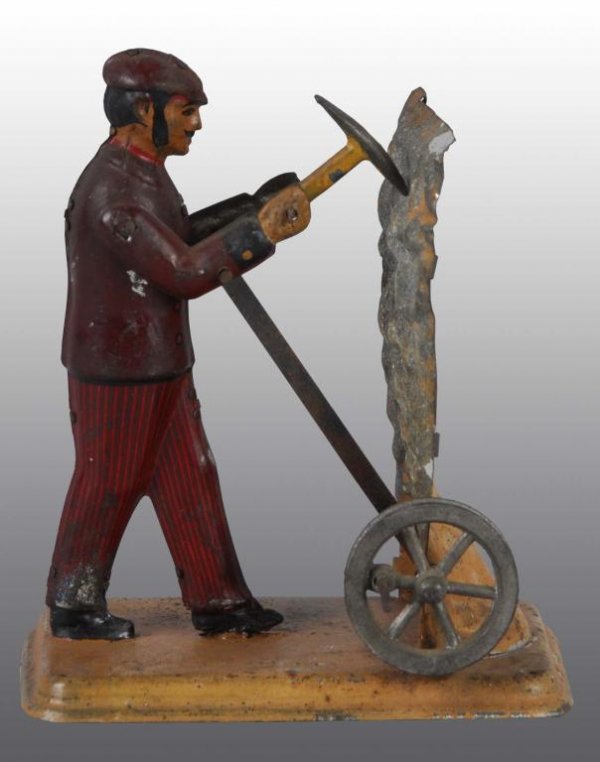 Carette Miner No 195/2 Steam Toy.: Description German. Made circa 1911. Miner has a pick axe and picks at a wall of rock. Some overall wear. Condition (Very Good). Size 5" T.