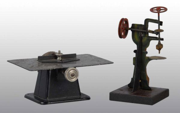 Lot of 2: Steam Toy Accessories.: Description A Marklin no. 4259 circle saw together with a tin drill press on wood base. Condition (Very Good). Size Largest: 2 - 1/2" x 6". Base; 3 - 1/2".