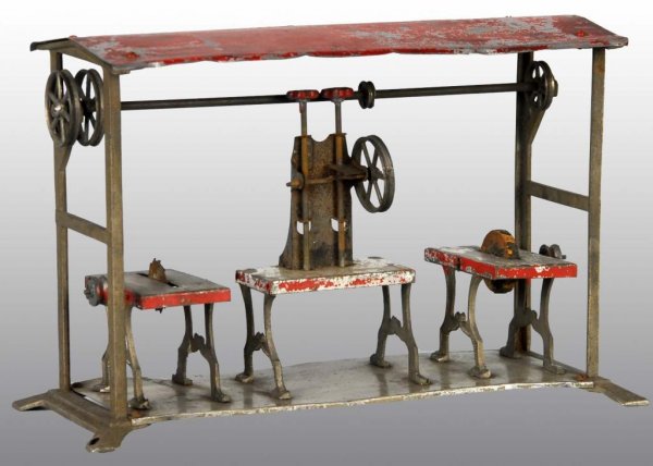 Tin Hand-Painted Workshop Toy.: Description Includes saw press and knife grinder. Moderate paint loss, especially to roof. Condition (Good - Very Good). Size 10 - 1/2" L.