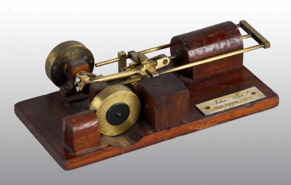 John Fish NYC Patent Model.: Description This well made wood and brass model of a steam engine was the invention of John fish of New York City. The patent information is unknown. Condition (Very Good). Size 10" L.