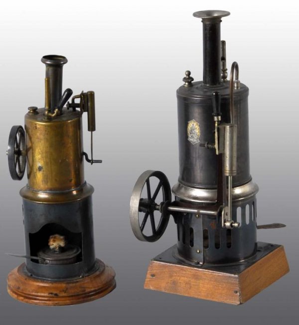 Lot of 2: Vertical Steam Engine Toys.: Description The first is a Bing no. 8086 Vertical Steam Engine. This engine was sold by Sear Roebuck for 98 cents in 1895. Complete with wood base, a burner, an oscillating cylinder and a whistle. The