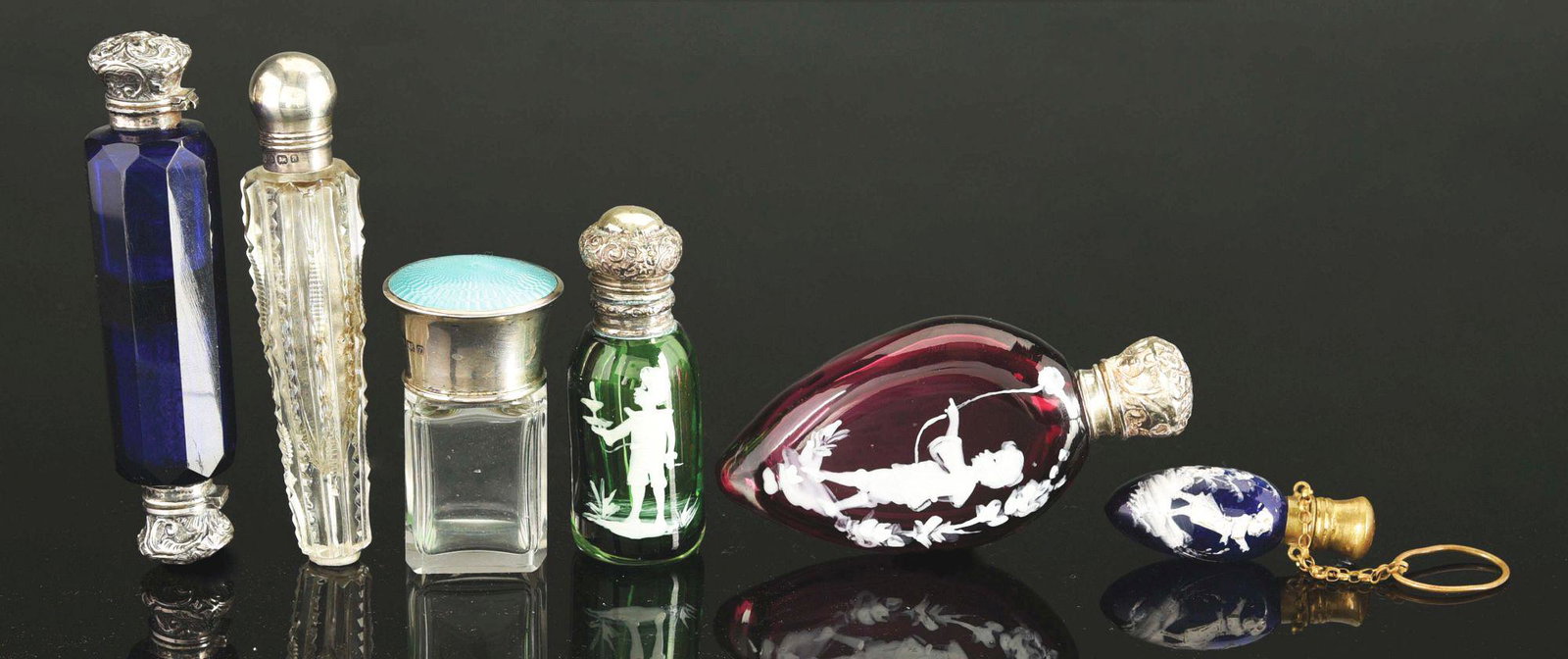 LOT OF 6: ANTIQUE SCENT PERFUME BOTTLES.: Lot of six antique scent or perfume bottles, includes: first, a Mary Gregory on ruby glass with boy flying kite, silver top and stopper, 3 - 3/4" long; second, a Mary Gregory on green glass with boy h