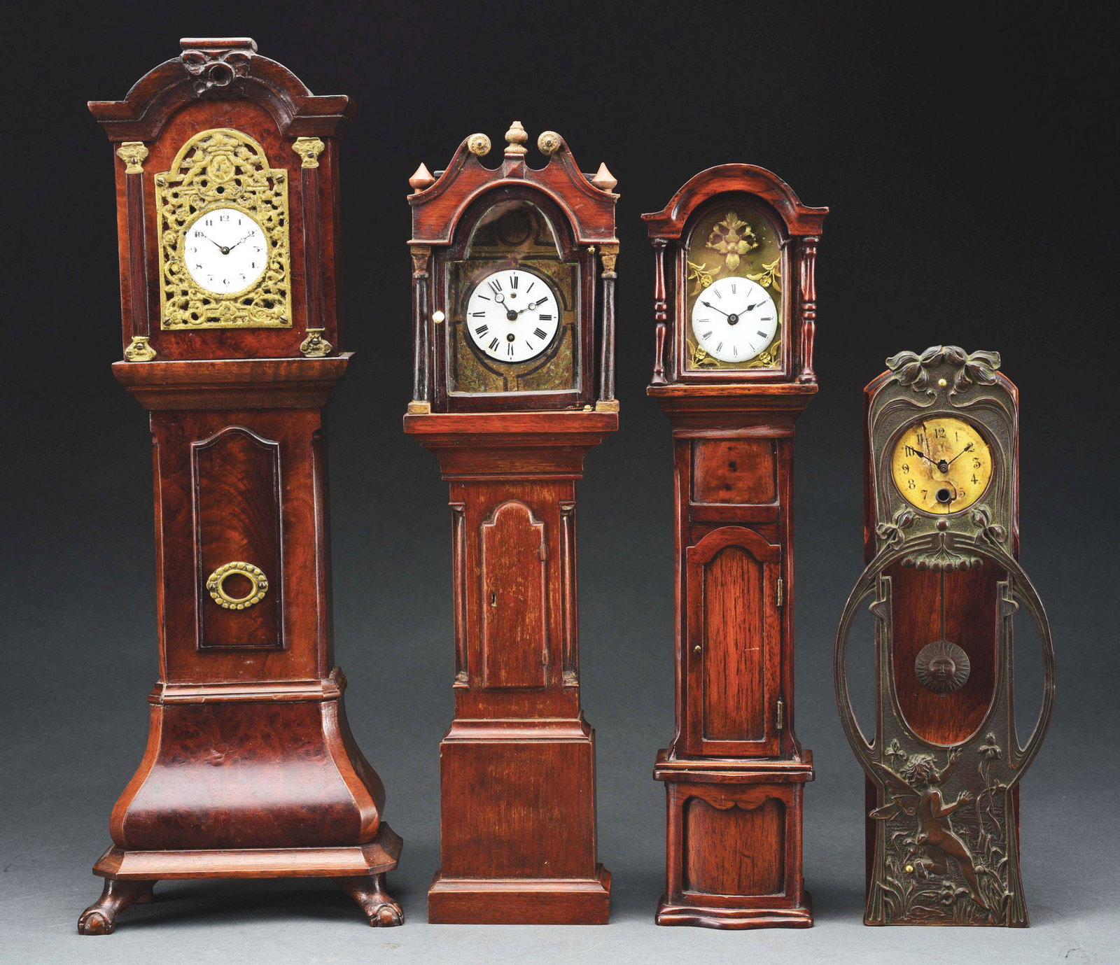 LOT OF 4 MINIATURE GRANDFATHER CLOCKS.: Four 19th century miniature clocks : 1. Dutch style bombe base with key wind movement; 2. English Chippendale style case with a pocket watch movement; 3. Art Nouveau bronze front open well key wind mo