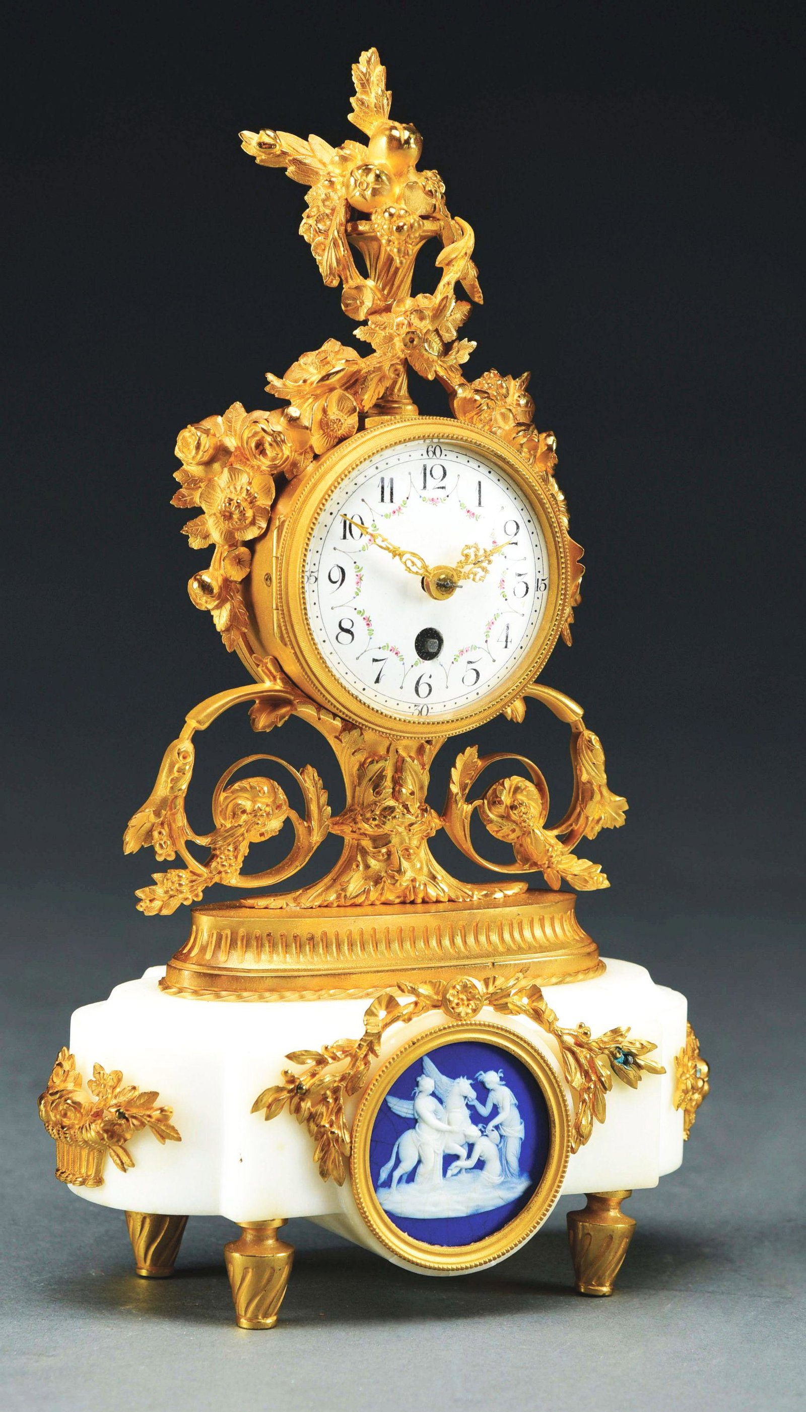 MARBLE AND ORMOLU CLOCK WITH INSET WEDGEWOOD PLACQUE.: French, circa 1900. Polychrome enamel dial. Minor fractures to marble base. Condition: (Very Good). Dimensions: 11 - 1/2" x 7" x 3 - 1/4".