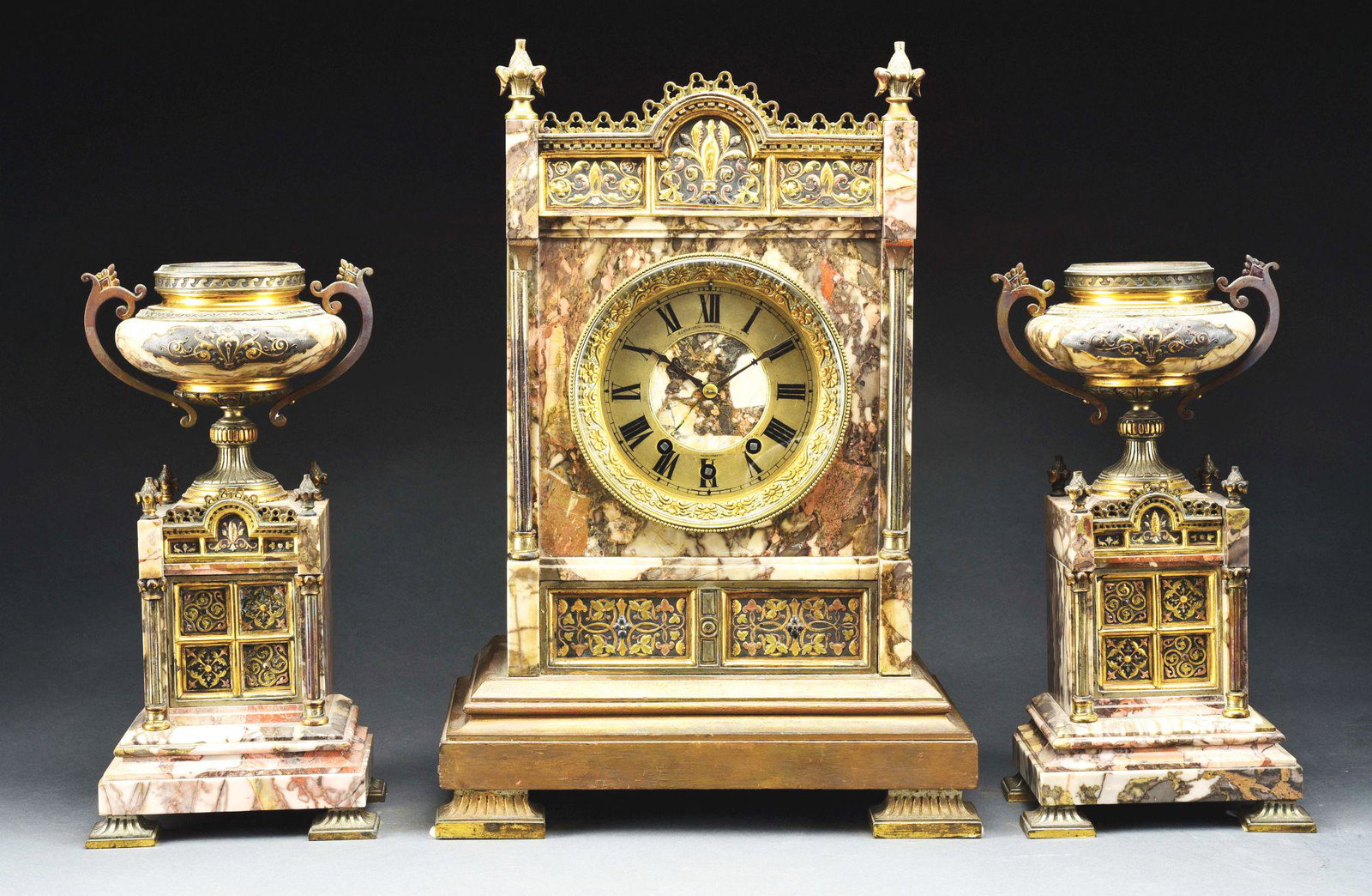THREE PIECE CLOCK GARNITURE.: Retailed by Schneider, Campbell and Company, New York. Marble, ormolu mounted and wooden clock with three train movement. Silvered brass and marble dial. Accompanied by two mounted urns. French, circa