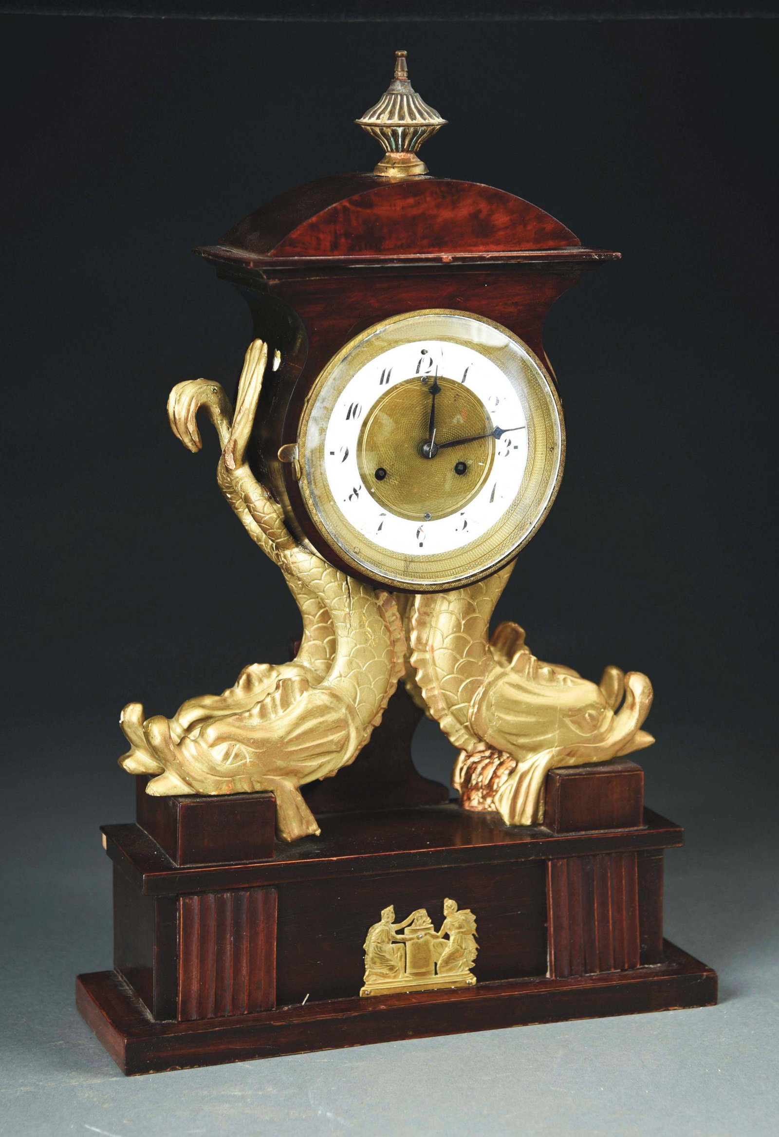 AUSTRIAN NEOCLASSICAL CASED CLOCK WITH DOLPHINS.: Enamel and gilt dial, time and strike. Circa 1840. Repairs and restoration. Morphy's Auction does not guarantee clocks to be in working order. Condition: (Fair). Dimensions: 19" x 12" x 4 - 1/4".
