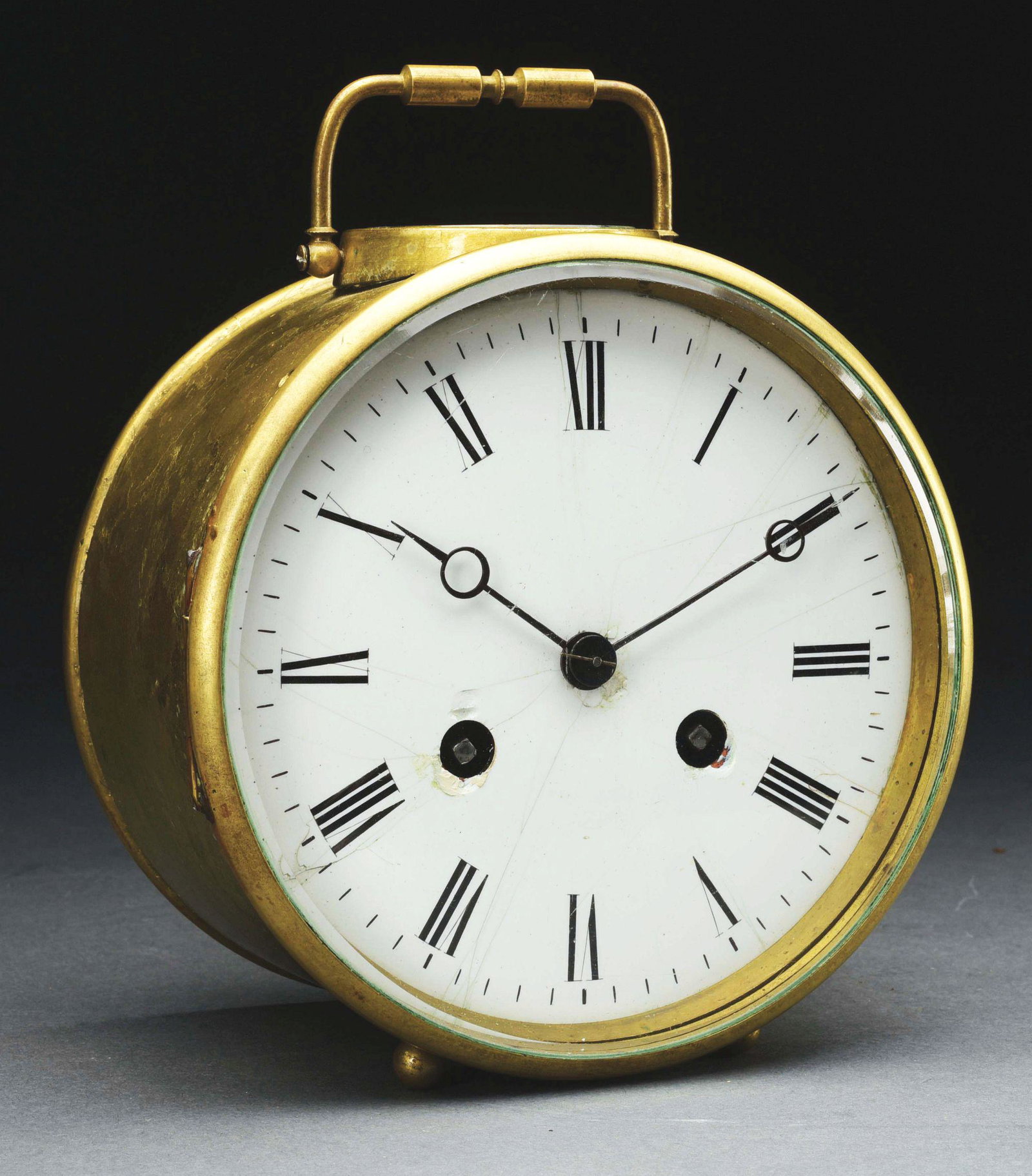 ROUND TABLE CLOCK.: French brass table clock. Enamel dial. Circa 1890's. Dial damaged. Condition: (Fair). Dimensions: 6 - 1/2" x 5 - 1/2" x 3 - 1/4".