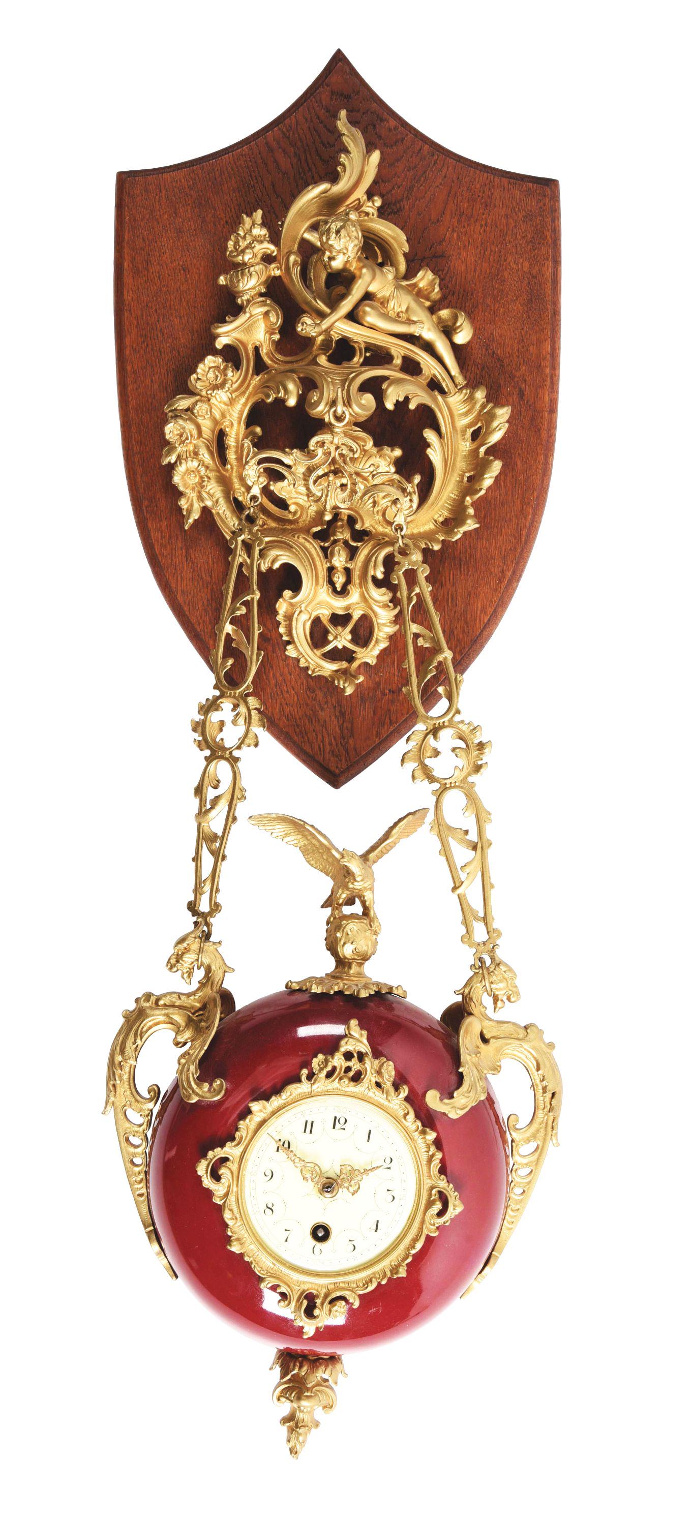 FRENCH HANGING CLOCK.: Enamel body and dial suspended from an oak plaque with brass mounts. Time only, single key wind movement. France, circa 1890's. Condition: (Good). Dimensions: 30" x 9 - 1/2" x 4".