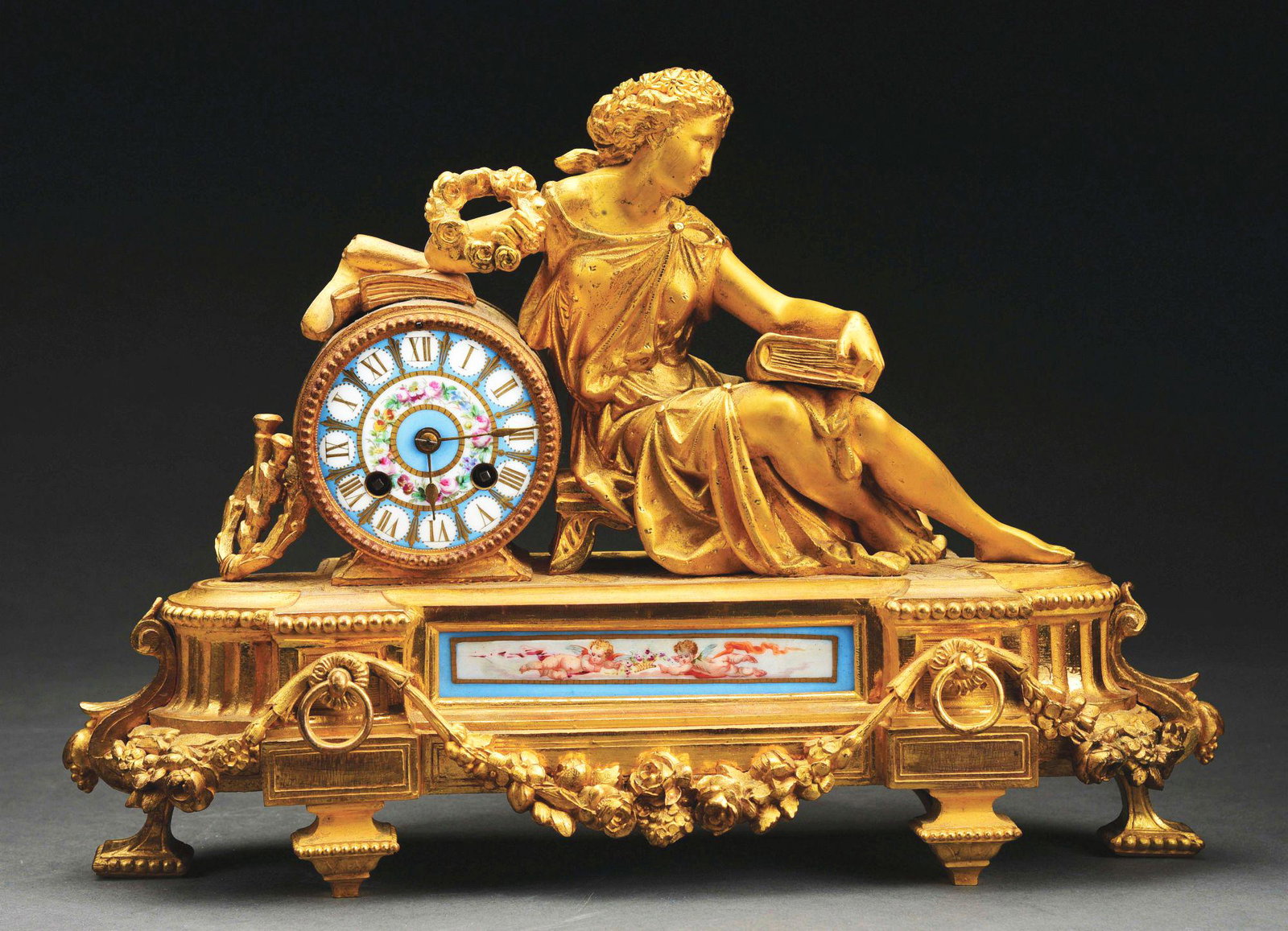 GILDED CCLOCK WITH RECLINING GODDESS.: Hand painted porcelain dial and inset panel. All parts and gilding intact with no cracks or damages. Time and strike. French, circa 1870. Condition: (Excellent). Dimensions: 11 - 1/2" x 16" x 7".