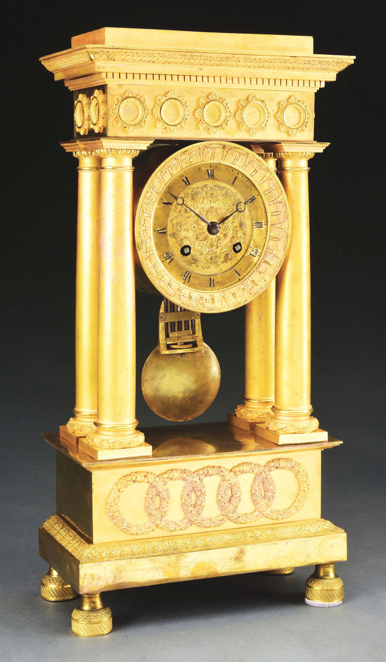 EMPIRE PORTICO CLOCK.: French, mid-19th century. Ormolu mounted fire gilt frame, dial signed by the maker. Morphy's Auctions does not guarantee clocks to be in working order. Condition: (Good). Dimensions: 18 - 1/2" x 9 - 1