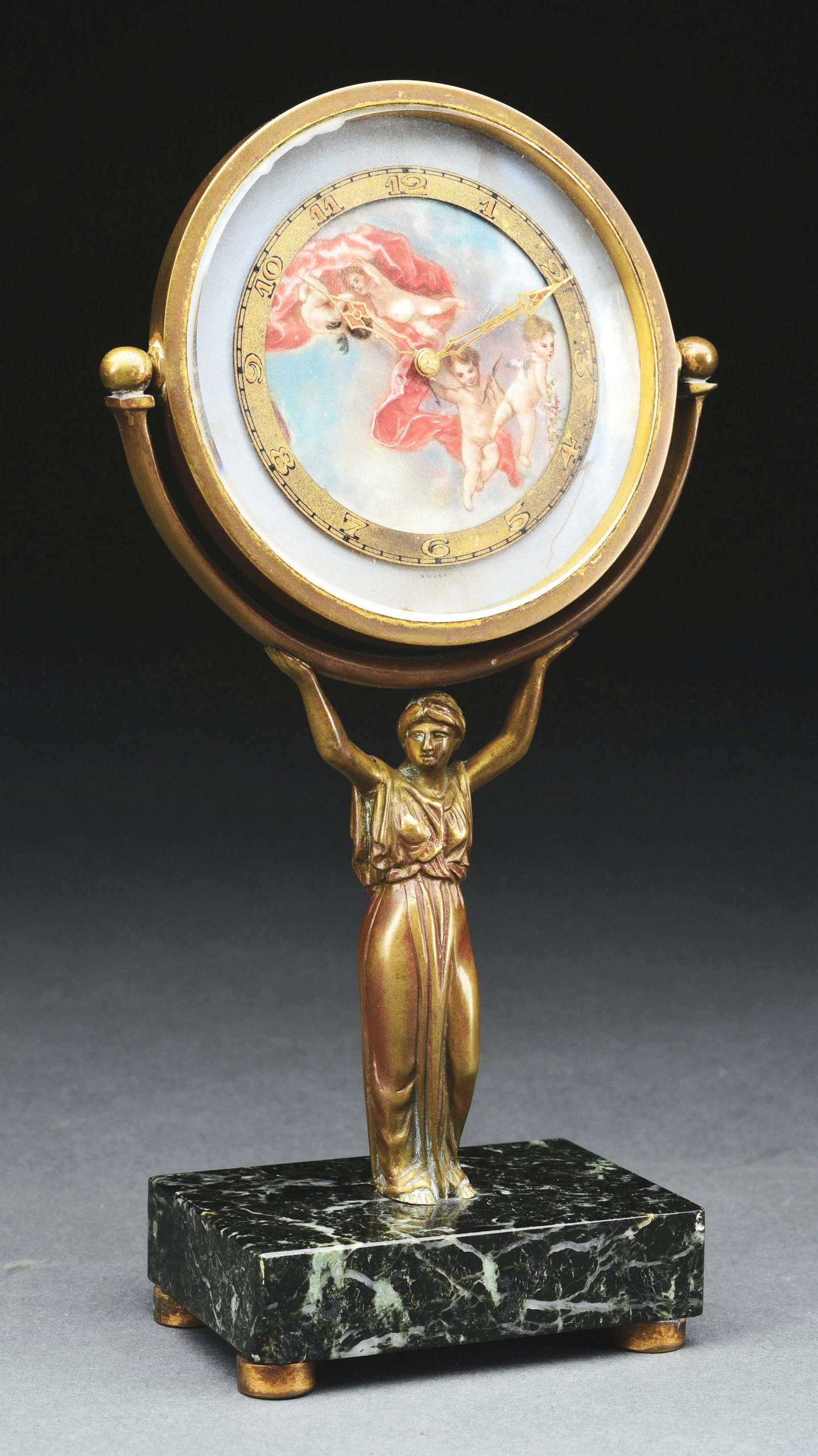 DESK CLOCK WITH DECORATED DIAL.: Bronze and marble. Hand painted enamel dial signed by artist. 8-jewel swiss movement signed :"EV CHEVRON". Circa 1920. Dial with damage. Condition: (Good). Dimensions: 7 - 5/8" x 4" x 2".