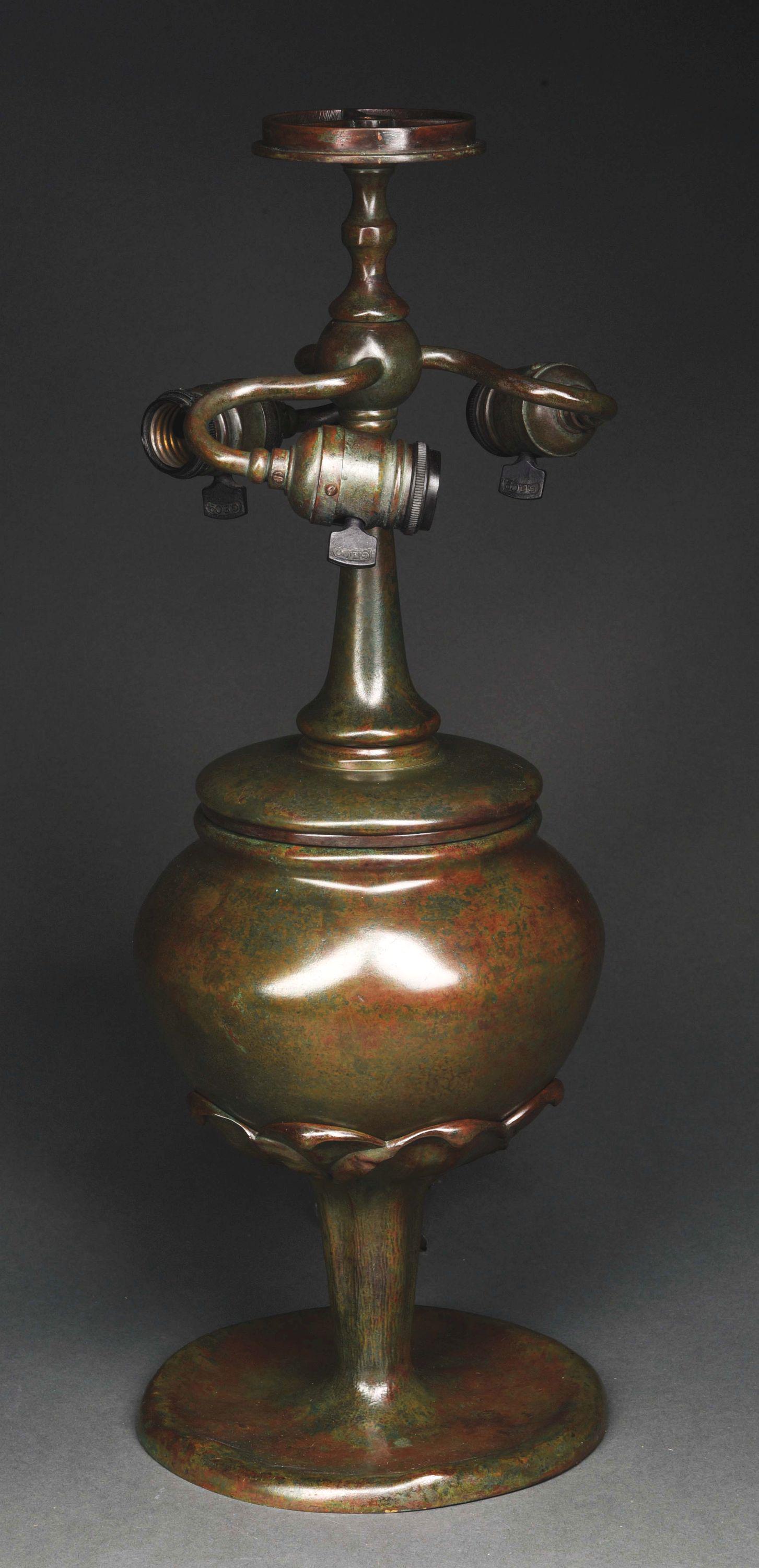 TOBACCO LEAF TABLE LAMP BASE.: A rare Tiffany Studios patinated cast bronze “Tobacco Leaf” table lamp base, decorated with a tobacco leaf decoration at the bottom of the base, with organic pedestal foot finished in its original