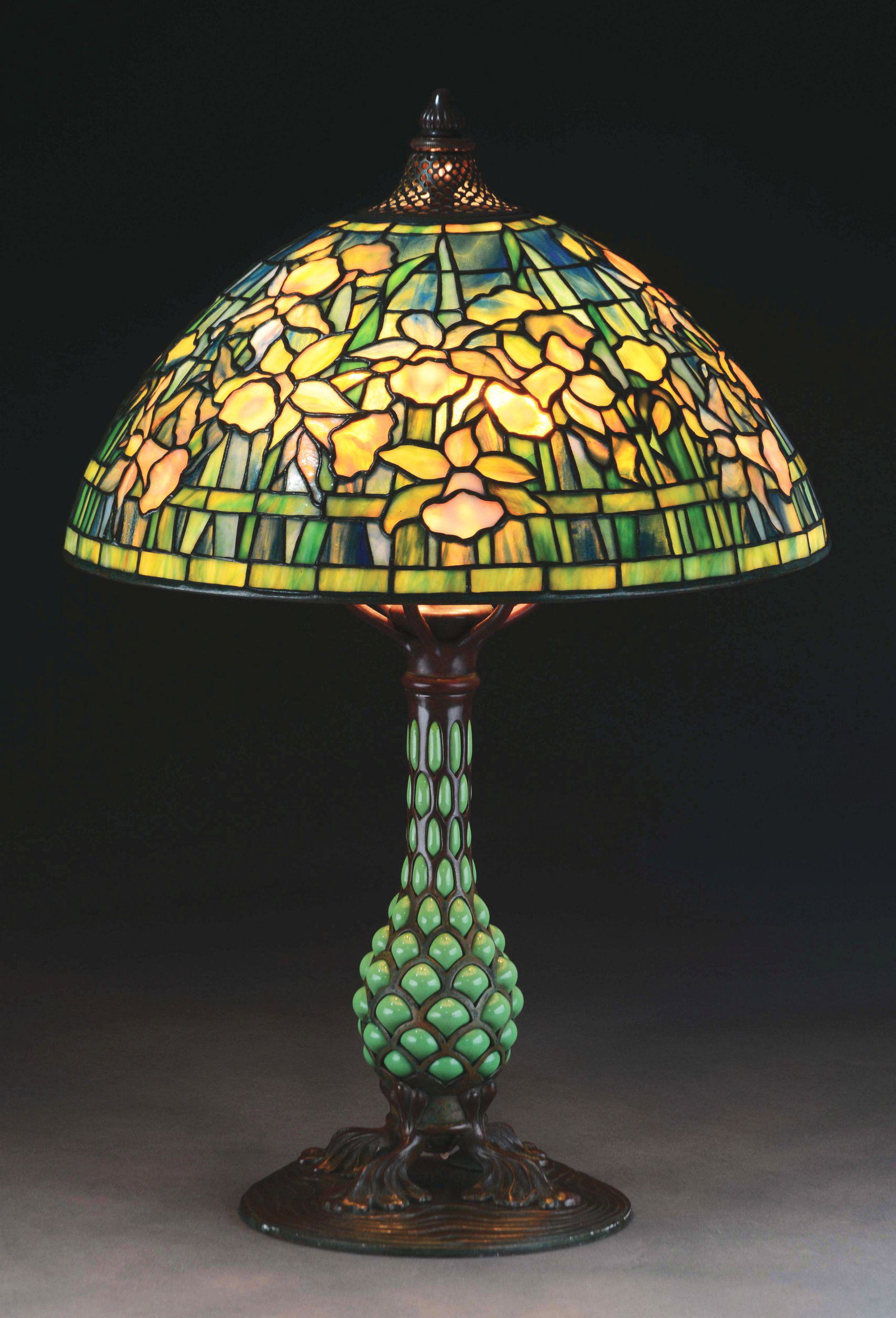 TIFFANY STUDIOS DAFFODIL TABLE LAMP.: Tiffany Studios table lamp has leaded glass dome shade with mottled yellow Daffodils and green leaves set against a rich striated blue background. This shade exhibits some of the finest deep colors. T