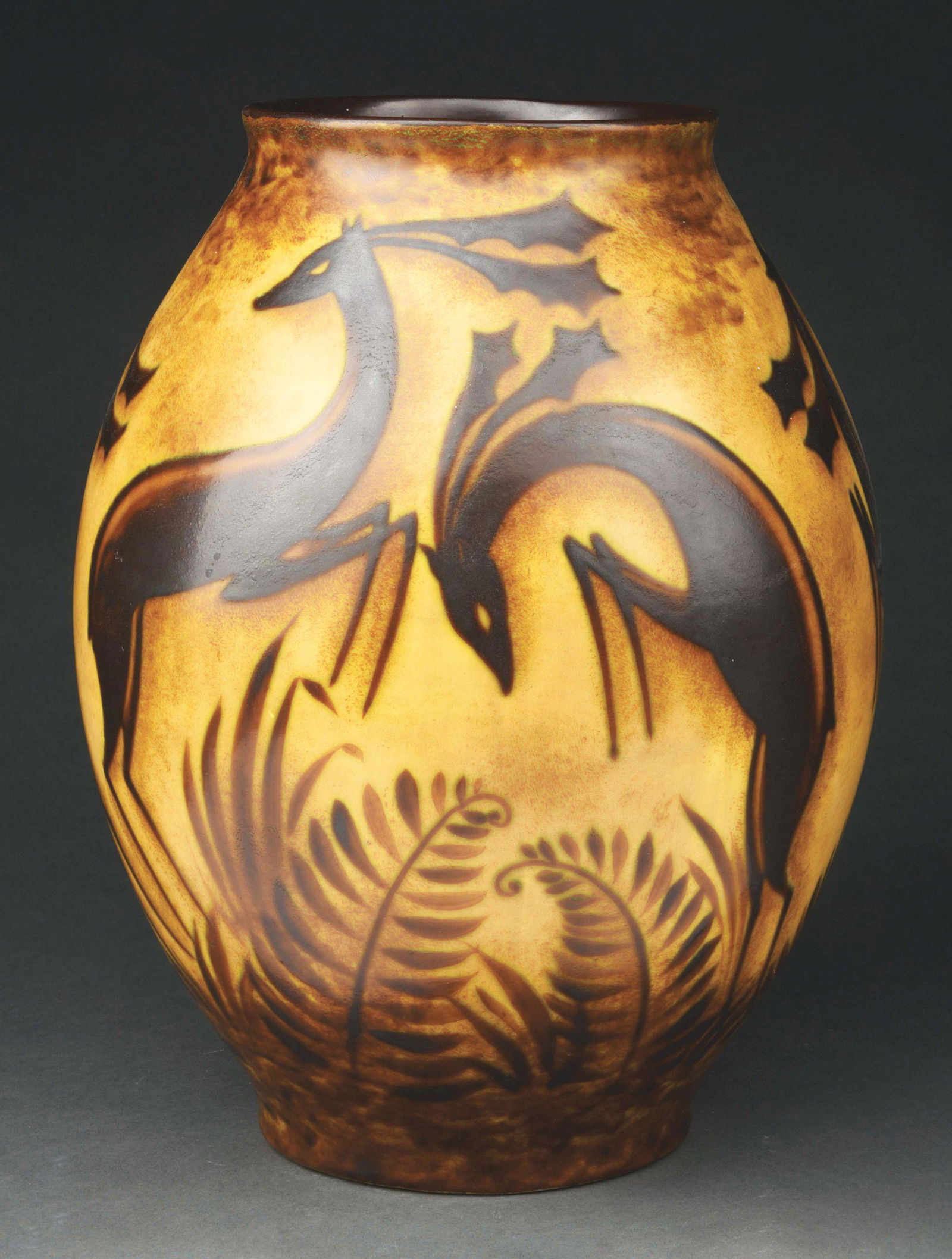 BOCH FRERES AFRICAN VASE WITH GAZELLE BY CHARLES: A beautiful Boch Freres vase by Charles Catteau. The African-themed vase features a tan and brown ground with prancing gazelle and large ferns. The vase is in excellent condition, free of cracks, chip