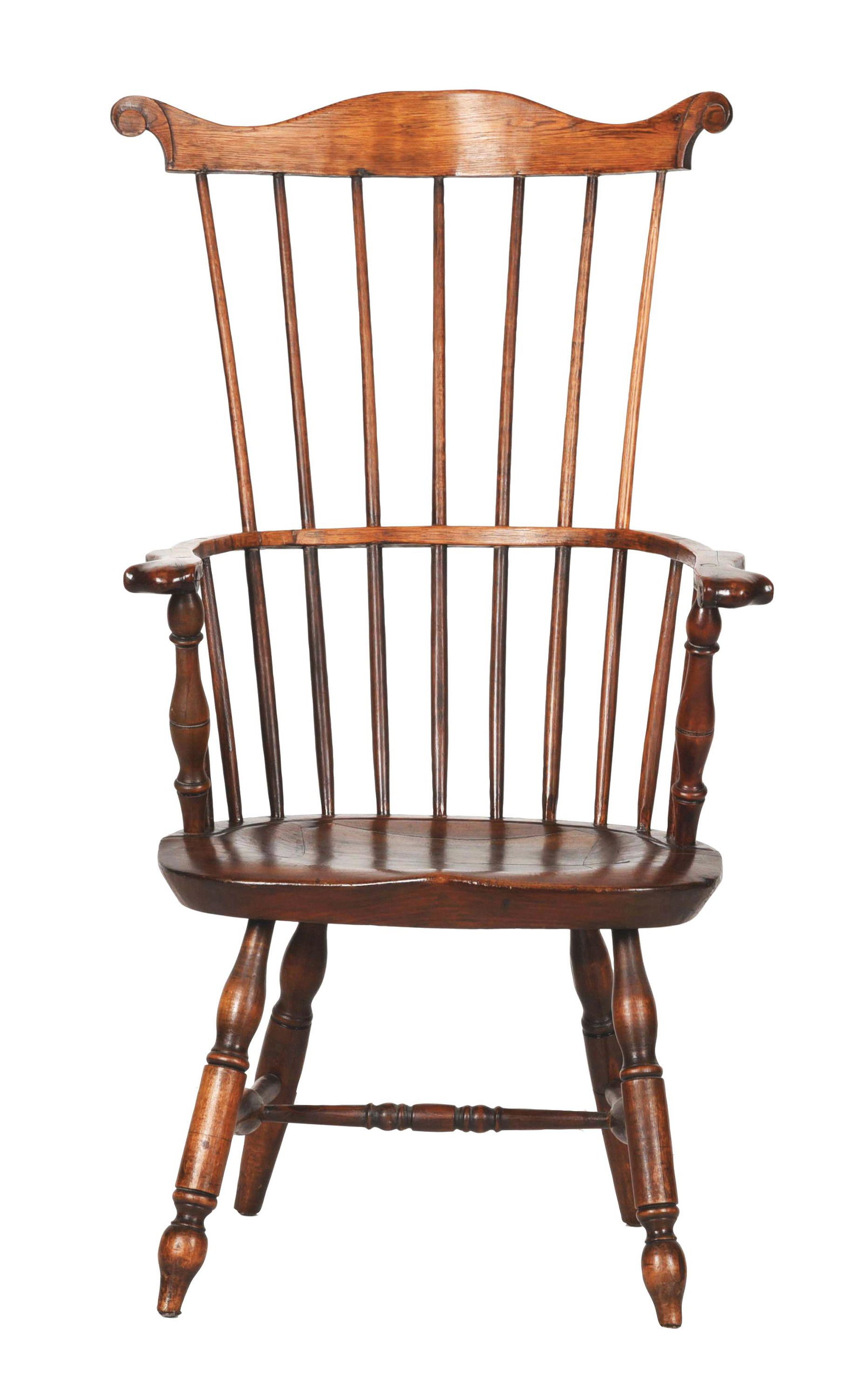 COMB BACK ARMCHAIR.: Pennsylvania, c. 1770. Mixed woods. High comb back with scrolled ears with bold knuckle arms and finely turned arm supports over a saddle seat with blunt arrow turned front legs and turned stretcher. 
