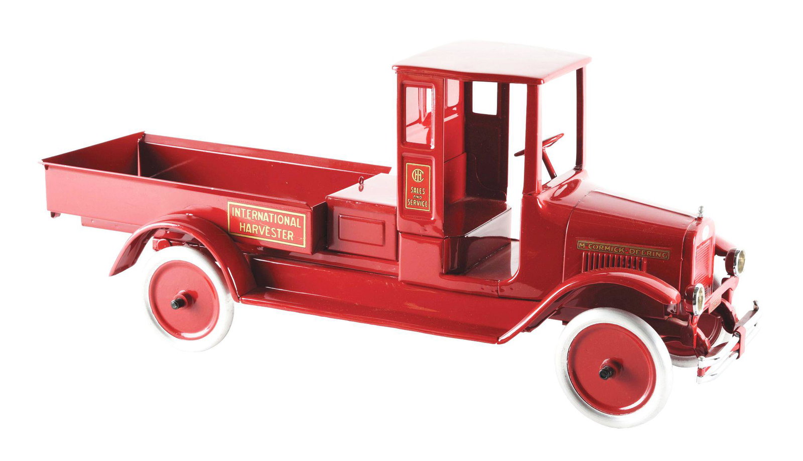 PRESSED STEEL INTERNATIONAL HARVESTER DUMP TRUCK.: Professionally restored. "International" decal on front. "Sales and Service" decal on both sides, "McCormick - Deering" decal on both sides of hood and "International Harvester" decals on both sides o
