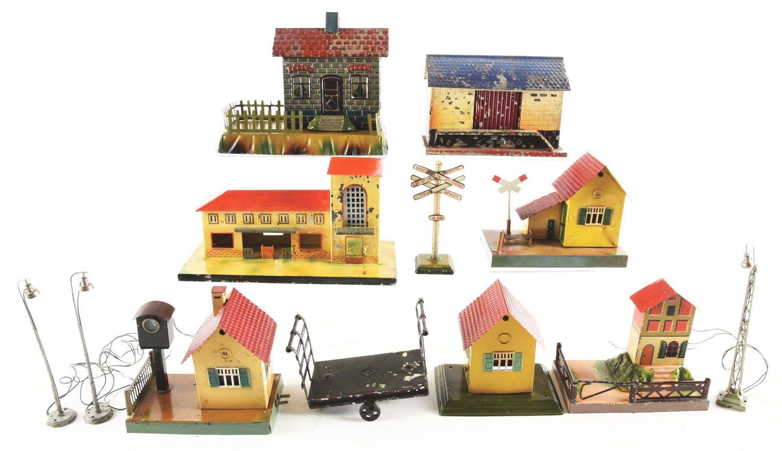 LOT OF 8: VARIOUS GERMAN HAND-PAINTED AND LITHOGRAPHED: Lot of eight various German hand-painted and lithographed small train stations. A few are marked "Marklin" on bottom, a couple are Bing and one is Kibri. There is a Bing baggage cart, some small railr