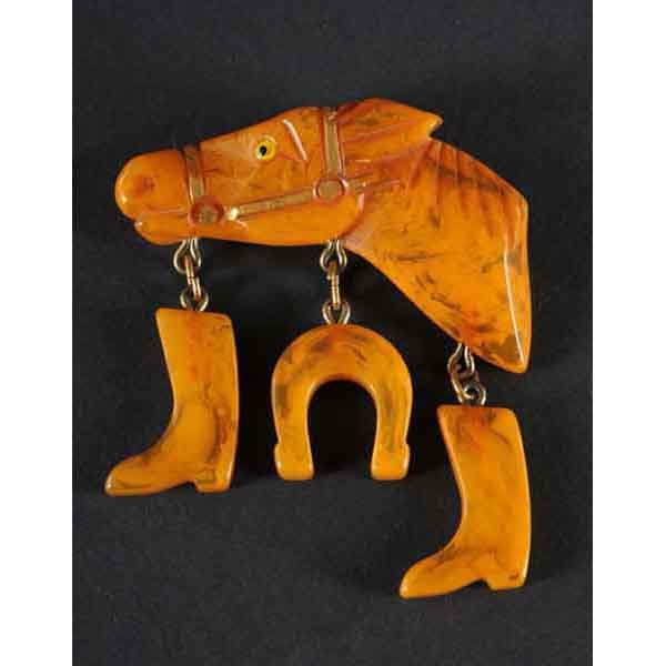 Bakelite Horse Head Pin.: With dangling boots and horseshoe. 2 - 3/4" L. (Excellent).