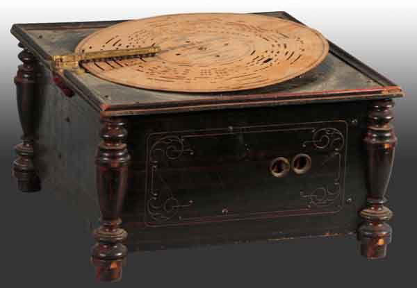 Wooden Music Box Organ Player.: Working. Plays paper records and includes six of them. 16" W. (Very Good - Excellent).