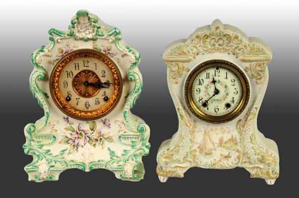Lot of 2: Time & Strike China Clocks.: One Ansonia marked "Wanderer" with crack and chip on back. Other is a Waterbury with ship decoration. Both have pendulums. Largest: 12 - 1/2" T. (Excellent).