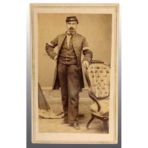 Unidentified Massachusetts Corporal CDV.: Full standing view with frock coat, vest, and cap. Marked "B.F. Day, East Abington, Mass". 4" x 2 - 1/2". (Excellent).