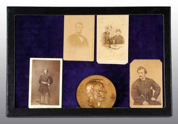 Lincoln & Booth Photos & Bronze Lincoln Coin.: Includes one Lincoln CDV with 3/4 view and no back markings, one Lincoln CDV with son Tad seated looking at album, one Colonel Elmer E. Ellsworth CDV with back marking, one John Wilkes Booth CDV with 