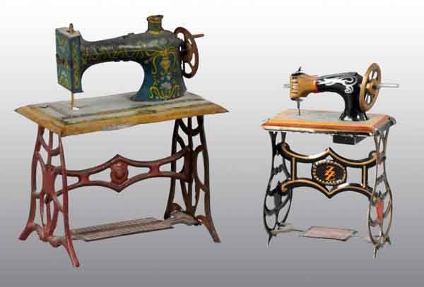 Lot of 2: Tin Sewing Machine Penny Toys.: German. Includes one marked "Made in Germany" and one marked "Gesch". Larger toy has a spot of litho loss on base. Largest: 2 - 1/2" T. (Very Good).