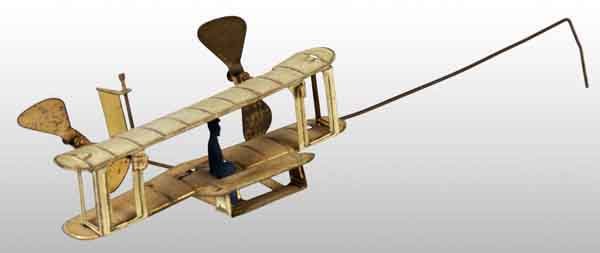 German Tin Litho Bi-Wing Airplane Handheld Toy.: German. Circa 1918. Unusual toy. When swung, propellers move around. Original, separate driver. Some pitting and wear to bare metal parts. (Very Good - Excellent).