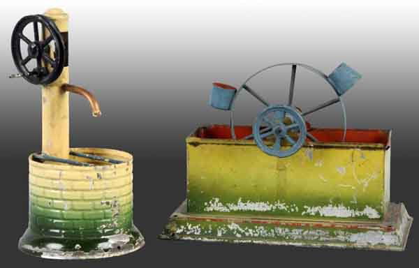 Lot of 2: Steam Accessories.: The one on the left is a pump and well. The accessory on the right is a "schopfrad" or water wheel. Some paint loss. Largest: 4" x 6". (Very Good).