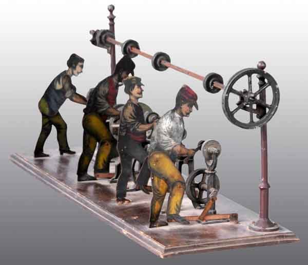 Carette Workshop with Workmen.: Attach your steam engine to the transmission and watch four workmen perform their work. Hard-to-find accessory. 7" x 17 - 1/4". (Very Good).