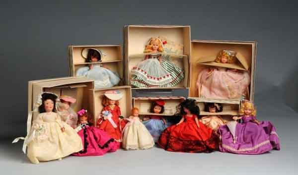 Lot of 12: Storybook Dolls.: American. Circa 1940 to 1950. Includes Nancy Ann rare bisque Little Miss Pattycake Baby #210 with curled fingers and no wrist tag and seven Nancy Ann Bisque dolls with stiff legs consisting of A Showe